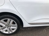 a close up of a white car parked in a parking lot