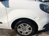 a small white car parked in a parking lot
