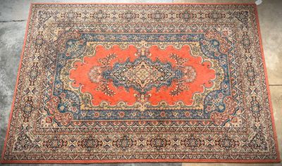 an orange and blue rug with a medallion design on it