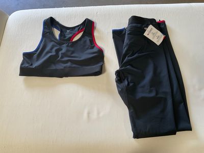 two pieces of clothing are laying on a bed next to each other