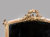 a mirror with a gold frame and a black background