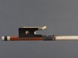 a close up of a violin bow with a piece of wood sticking out of it