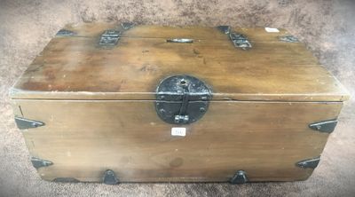 a small wooden box with a metal latch on it
