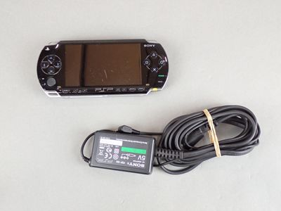 a game console and a charger on a table