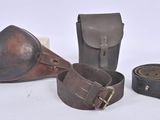 three pieces of leather are sitting next to each other on a white surface