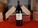 a bottle of wine sitting on a table next to a stack of boxes