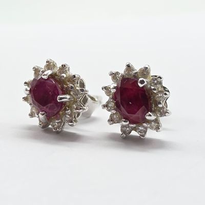 pair of ruby and diamond earrings on a white background