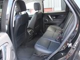 the back seats of a car with the door open in a parking lot