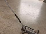 a man using a floor sweeper in a garage