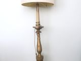 a lamp that is sitting on the floor next to a wall