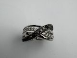 a close up of a ring with black and white diamonds on it