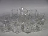 a lot of glasses and a pitcher sitting on a table
