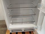 a white refrigerator that is open on a pallet
