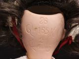 a close up of a doll ' s head with a doll ' s hair