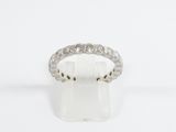 a close up of a diamond ring on a white surface