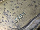 a close up of a bronze plate with a number on it