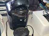a coffee maker sitting on a counter next to a toaster and a toaster