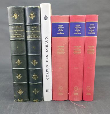 four books are lined up in a row on a gray surface