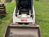 a bulldozer that is sitting in the grass