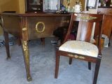 a desk with a chair and a mirror in the room