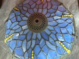 a blue and yellow mosaic bowl sitting on a table