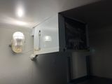 an image of a bathroom with a light on the wall