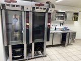 a commercial kitchen with stainless steel appliances and tile flooring