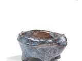 an image of a small ceramic bowl with a handle