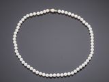 a cultured pearl necklace with a gold clasp