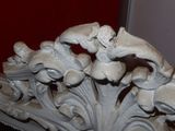 a sculpture of a bird on a branch in a room
