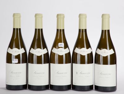four bottles of wine are lined up in a row