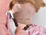 a doll that has a tattoo on it ' s neck