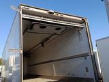 a truck that is parked in a lot with it ' s door open