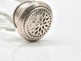 a salt and pepper shaker sitting on a white surface