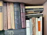 a box full of old books sitting on a table