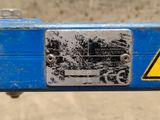 a close up of a sign on a blue piece of equipment