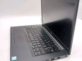a laptop computer sitting on a table with a keyboard