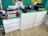 a woman standing in front of a display of electronic equipment