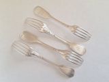 four forks and a spoon are arranged in a row on a white surface