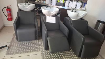 three chairs and a sink in a salon room