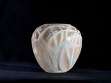 a vase that is sitting on a black surface