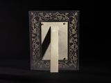 a black and gold picture frame with a letter n on it
