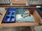 a table with a drawer full of tools on it