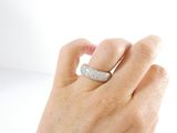 a woman ' s hand holding a ring with a diamond on it