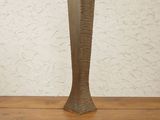 a vase that is sitting on a wooden shelf