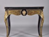 a black and gold console table with a marble top