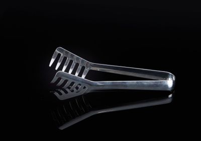 a fork that is sitting on a black surface