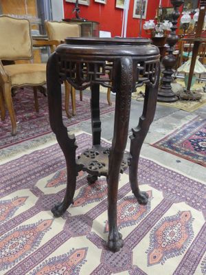 a small table with a wooden top in a room