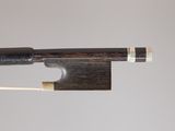 a close up of a violin bow with a wooden stick sticking out of it