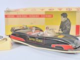 an image of a toy car with a man in the driver ' s seat in front of a box